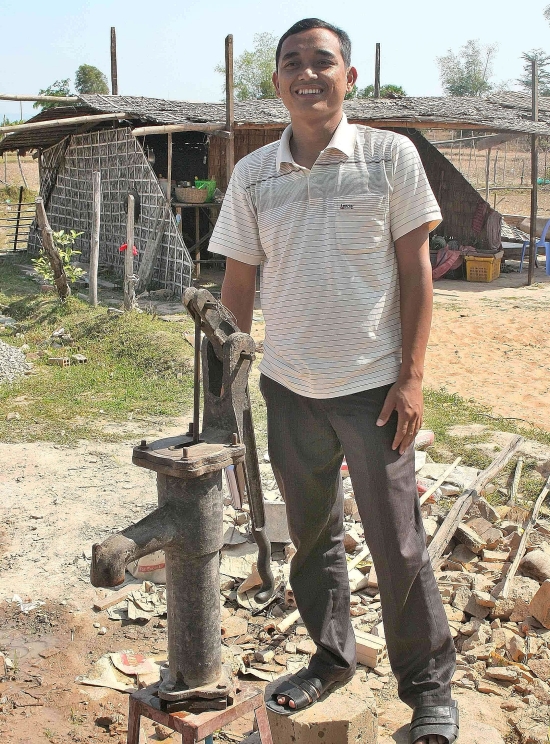 Founding father: Togh proudly shows off the new water pump at the village school