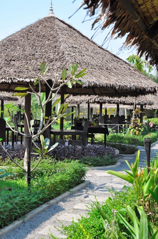 Private cabanas sit amidst lush gardens.