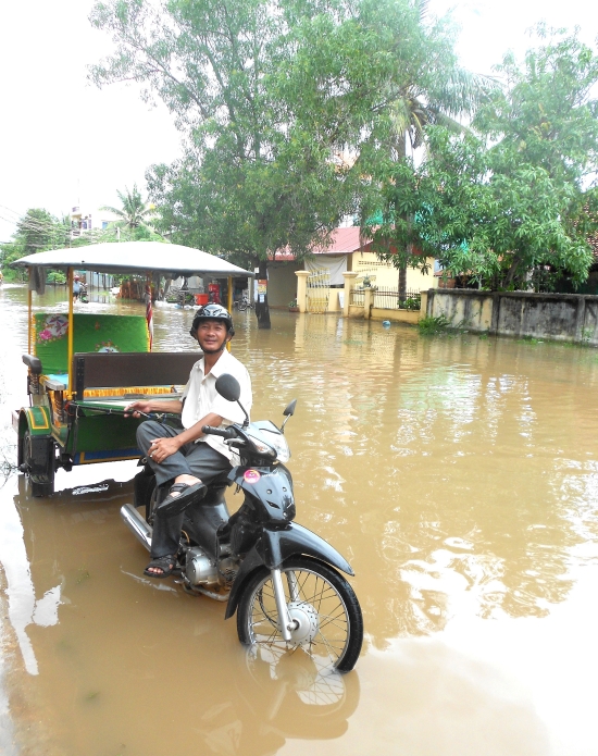 Your tuk tuk driver won't let a little thing like a flood put him off.