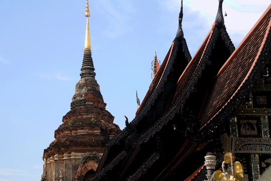 Viharn roof with chedi in background Viharn roof with chedi in background