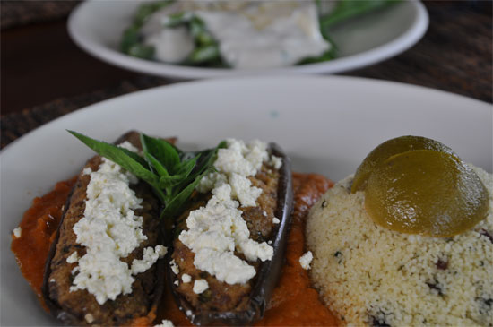 Baked eggplants on tomato sauce, filled with minced goat meat, topped with cheese, served with lemon and raison couscous and spinach and cashew nut salad with yoghurt dressing. 78,000 rupiah.