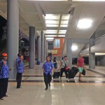 My 100,000 rupiah saviour approached. Note the tourists walking back into the terminal behind him.