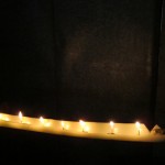 Candles are placed on a piece of banana tree trunk and decorated with flowers to resemble a racing boat. These 'candle boats' are placed in front of houses in celebration of Loy Khatung and the Boat Racing Festival.