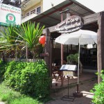 Cuisine D'or Vegetarian Restaurant offers a wide range of food and drink, and features outdoor seating with lush greenery.