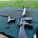 9mm pistol sitting next to the M16