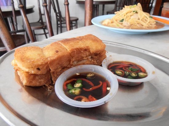 Deep fried roti babi with spicy dipping sauce.