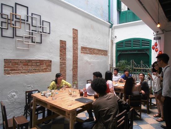 Contemporary design meets traditional shop house air well.
