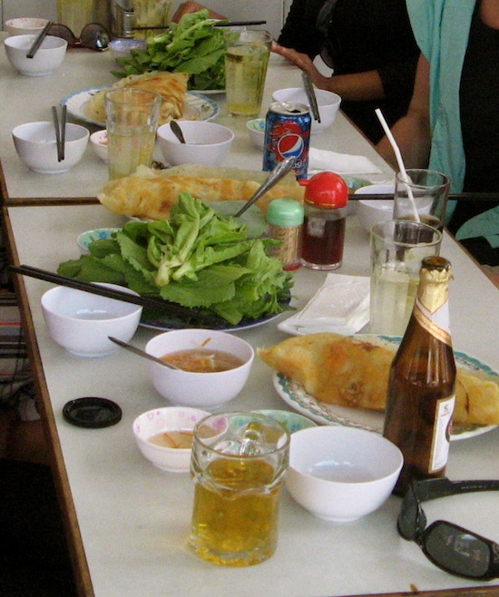 Why is the plate of extras bigger than the banh xeo? Why is the plate of extras bigger than the banh xeo?