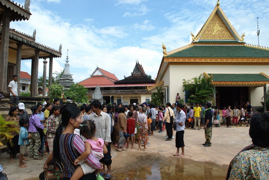 Families wait patiently for flood relief supplies last October, delivered by The Green Gecko Project, in partnership with the Hotel de la Paix, Heritage Suites hotel, Golden Banana and Exotissimo Travel