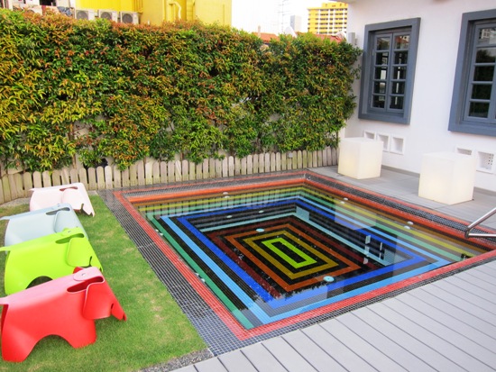 The jacuzzi is in a pleasant common area that provides a view of the surrounding estates.