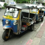 Classic blue and yellow Bangkok tuk tuks.