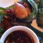Chicken in pandan leaves -- out of the wrapper and into the sauce.