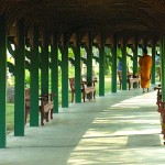 A monk strolls through one of Ancient Siam's many passages.