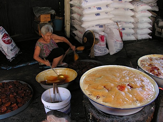 Boiling the bael fruit at Soi Mathum.