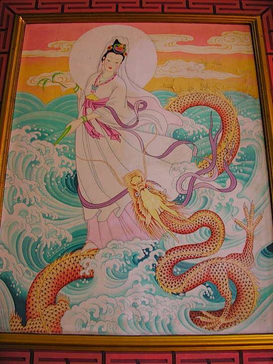 A mural shows Kuan Im with vase, willow branch ... and dragon.