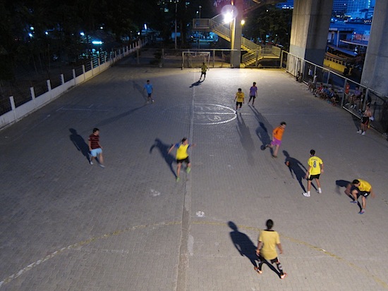 Nightly football action under Saphan Taksin.