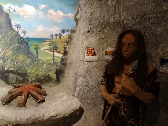 Stone-age man with weapon. Not a tuk-tuk driver.