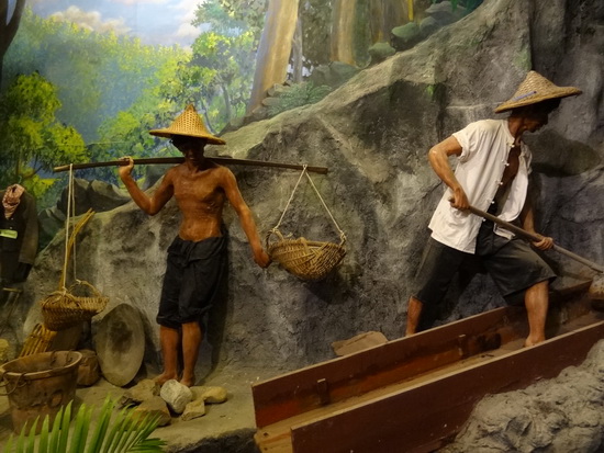 A scene showing some of the back-breaking tin-mine work.