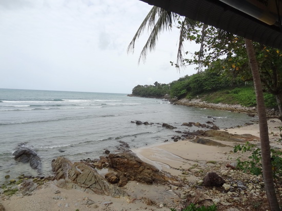 The rocky shore of Kalim beach stretches out below.