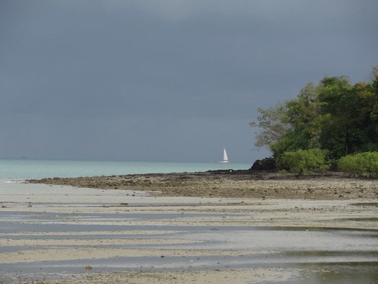 A sailboat seeks shelter from the storm on Phuket's east coast.