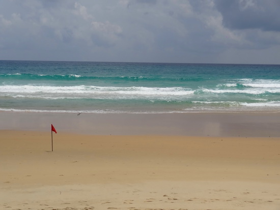 Red-flagged. A little beacon of doom on Karon Beach.