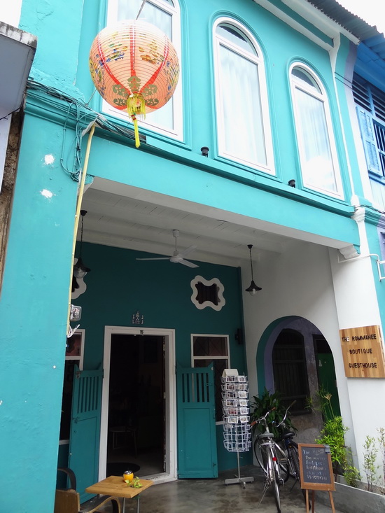 This teal-green guesthouse is found in a row of pastel-toned shophouses.