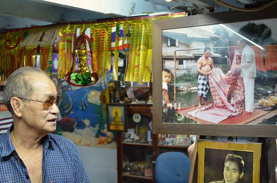 Auud shows us photos of Thompson (top right) in Baan Krua.