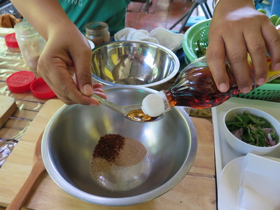 Measuring out the fish sauce and salty/spicy bits.