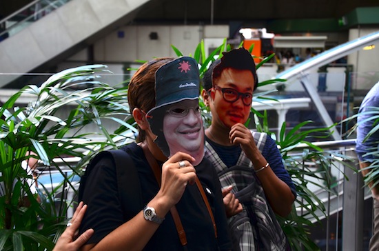 Some protesters wore masks of influential people on both sides of Thailand's political divide.