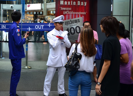 Terminal 21 staff inform shoppers that the mall is closed.