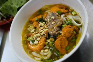 The soup with yellow noodles.
