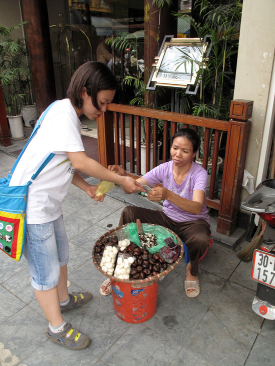 Yen picks up a few water chestnuts for us to try.