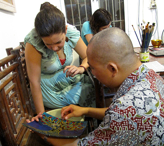 Tuan demonstrates sanding.