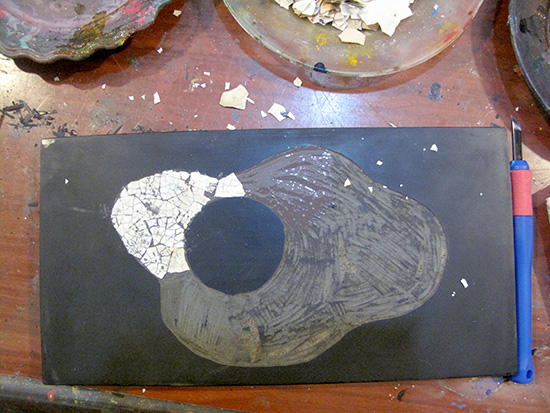 Next stick on the eggshell, using paint as an adhesive.